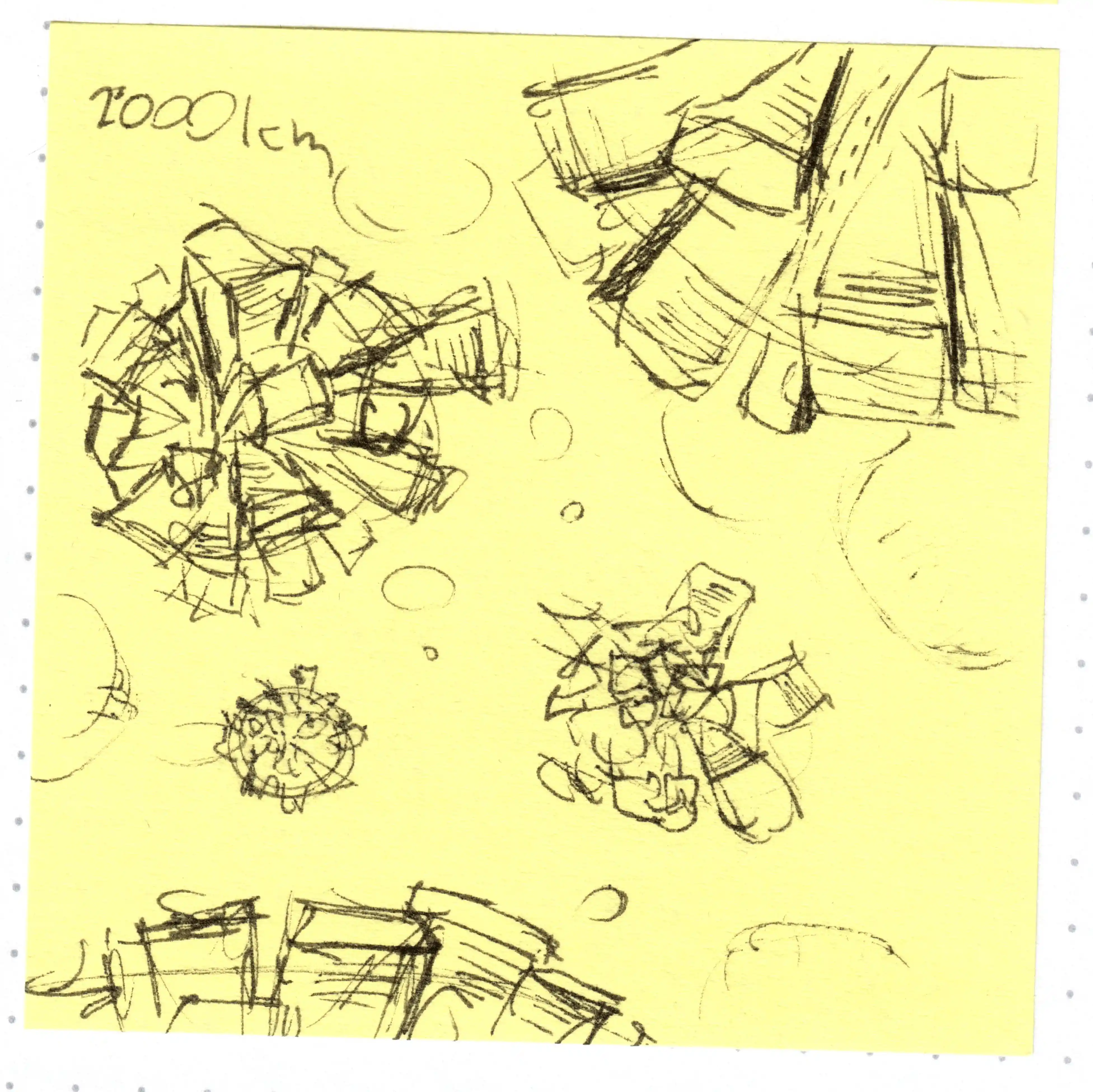 A post-it showing rough sketches of planets with skyscrapers on them.